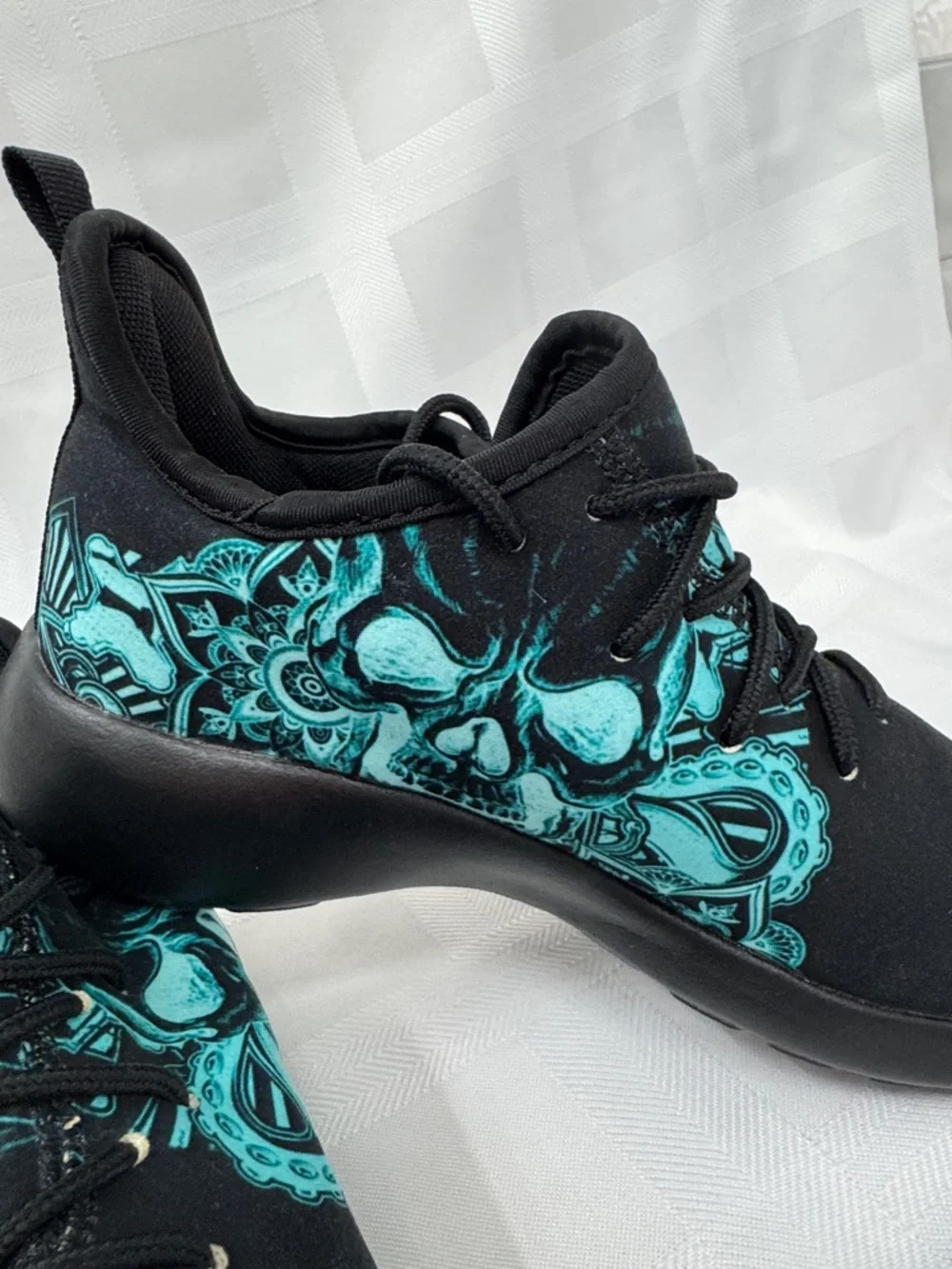 Unisex Black Lightweight Sneakers with Teal Skull Accent